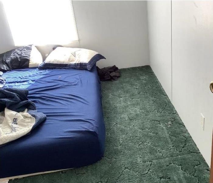 Wet carpet after flood in bedroom